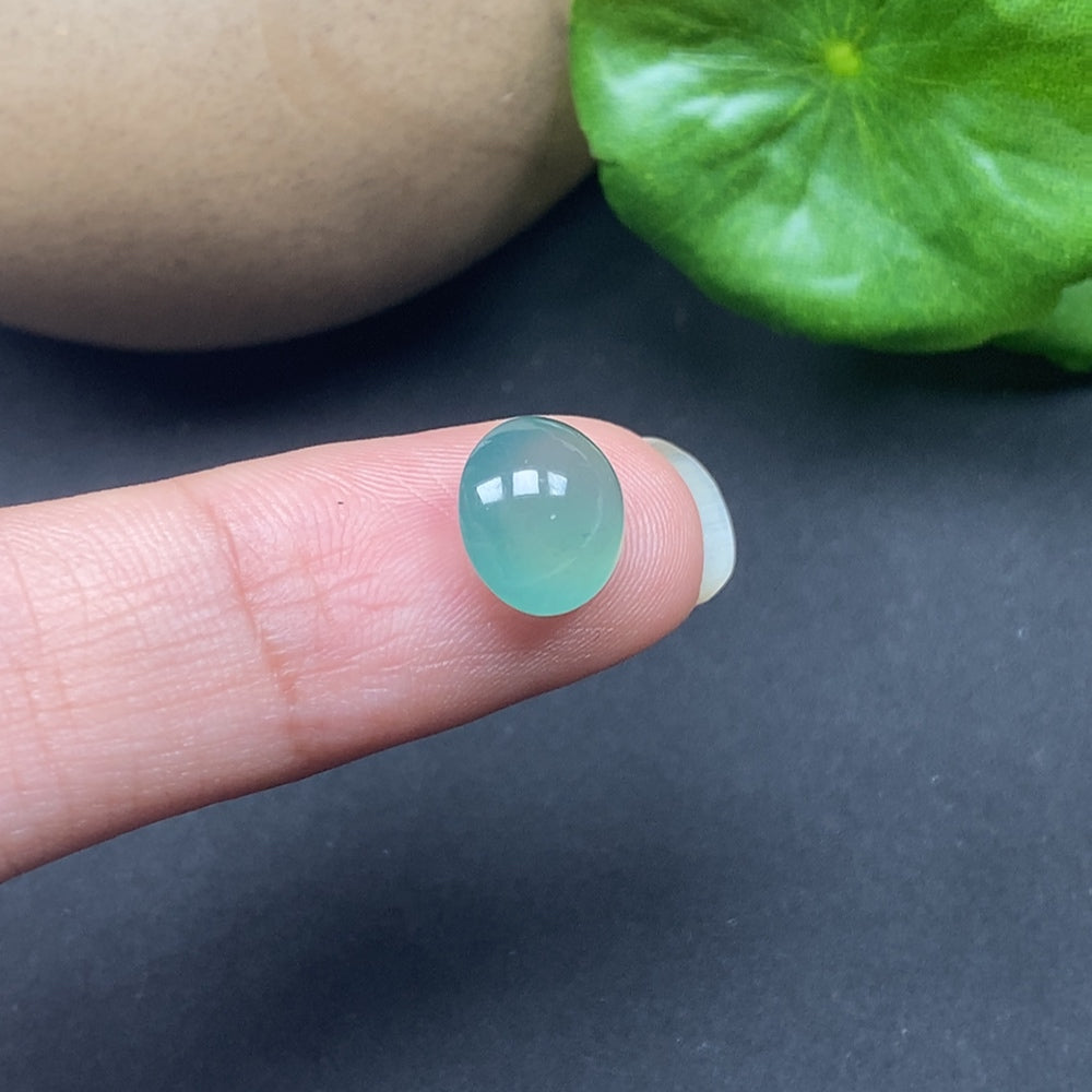 Close-up of HKHQ jadeite cabochon inlay showcasing smooth, polished green jade stone with natural variations and a glossy finish.