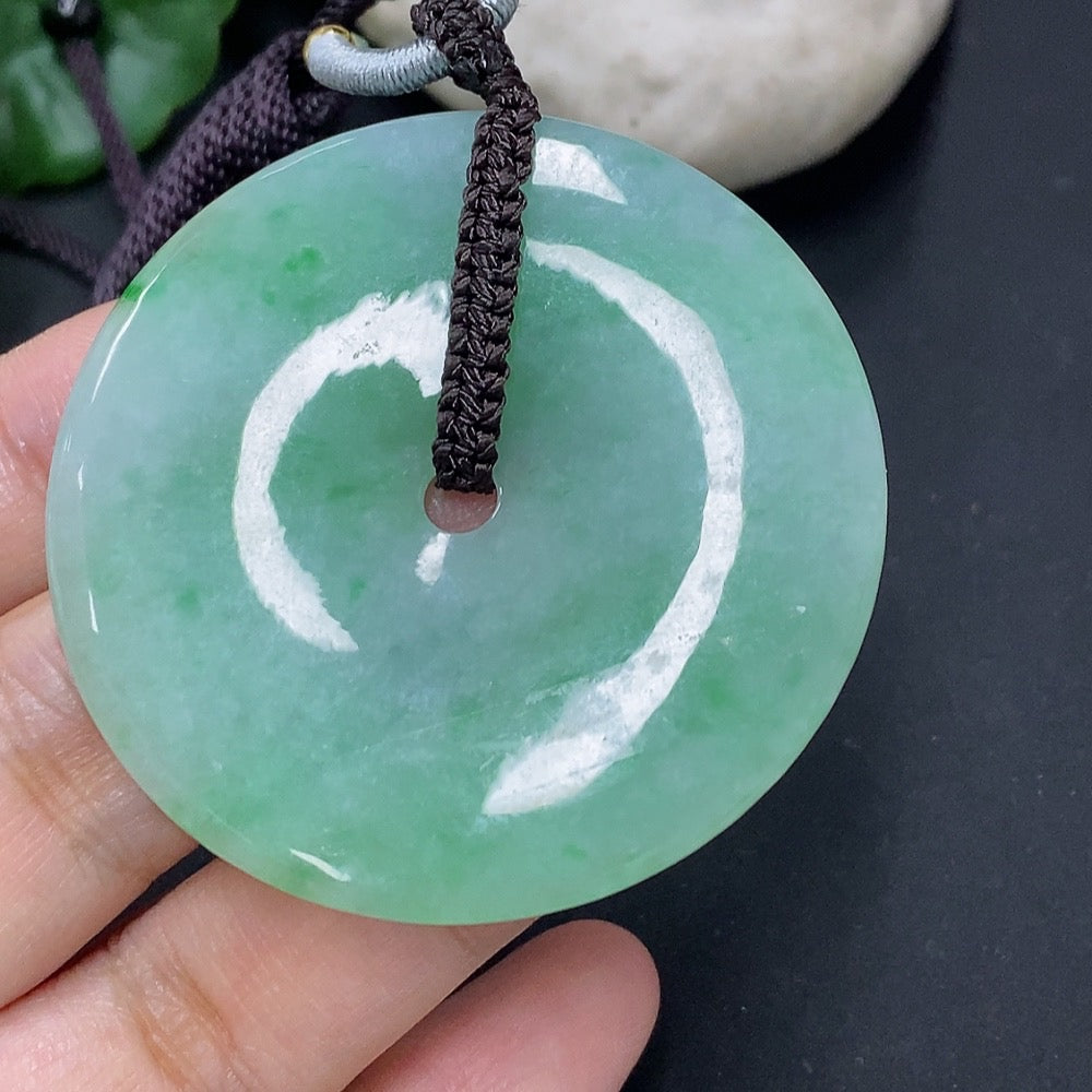 Jadeite pendant with peace knot design from HKHQ, featuring a jade-colored pendant and cord, weighing 28.34 grams.