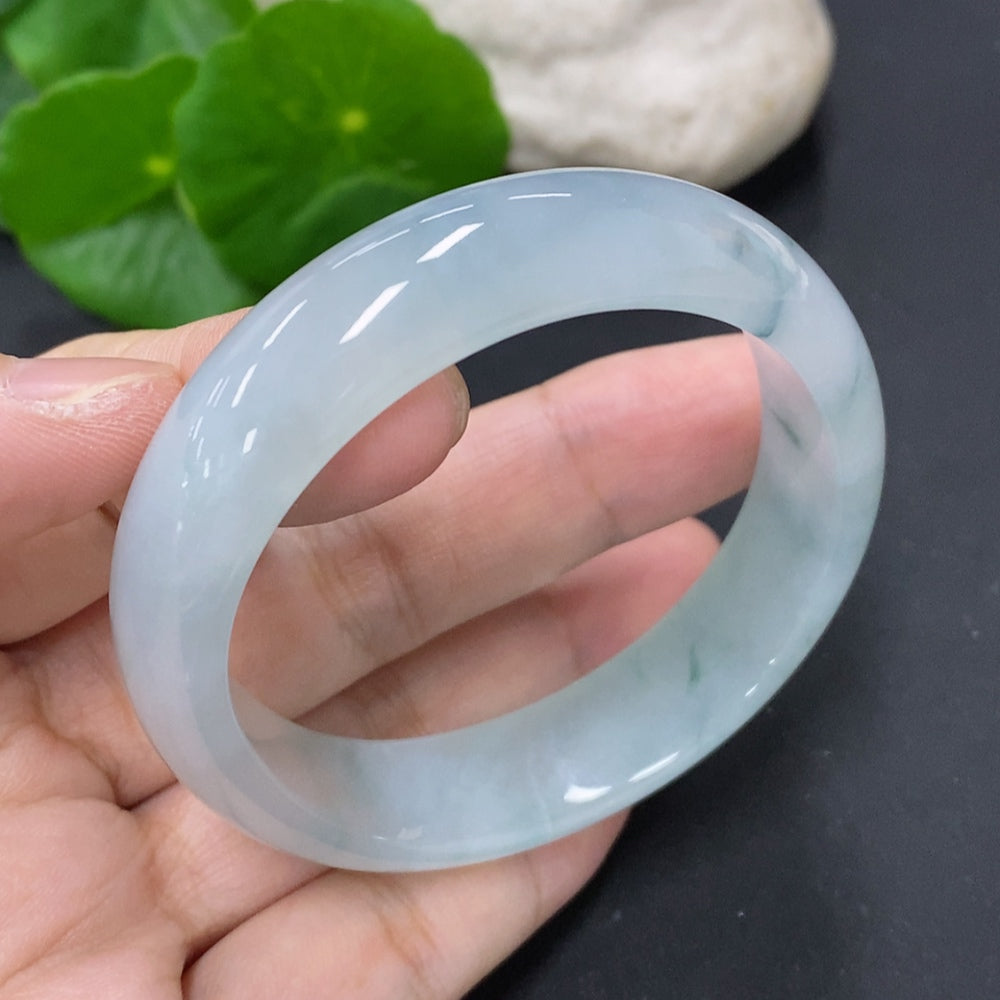 HKHQ jadeite oval bangle size 56, 43.7g, showcasing smooth, polished green jadeite bracelet on a neutral background.