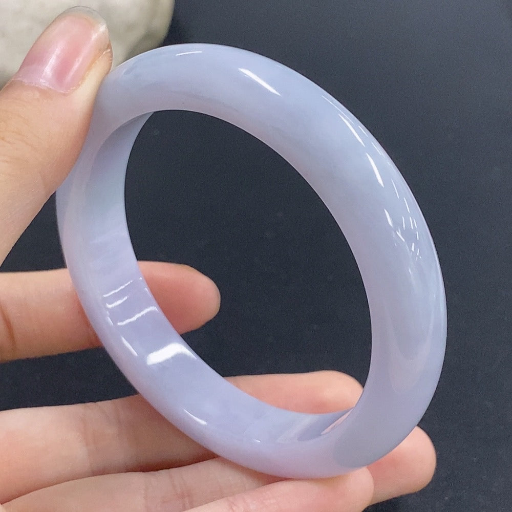 Jadeite round bangle with size 56.1 and weight 53.9g from HKHQ, showcasing smooth polished jade surface and circular shape.