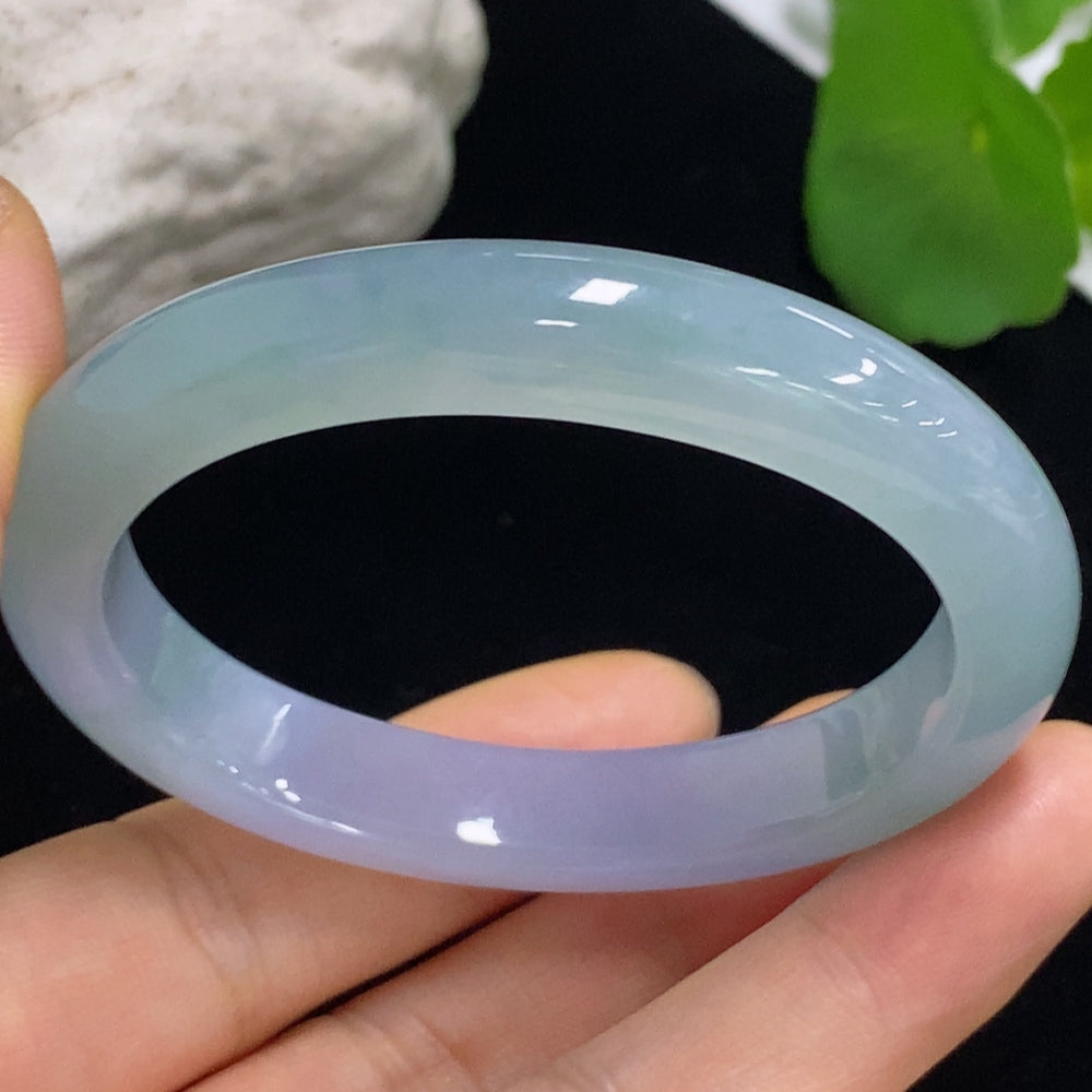 HKHQ Jadeite Oval Bangle in size 53.2 with a polished finish, showcasing its smooth, elegant design in vibrant green jadeite.