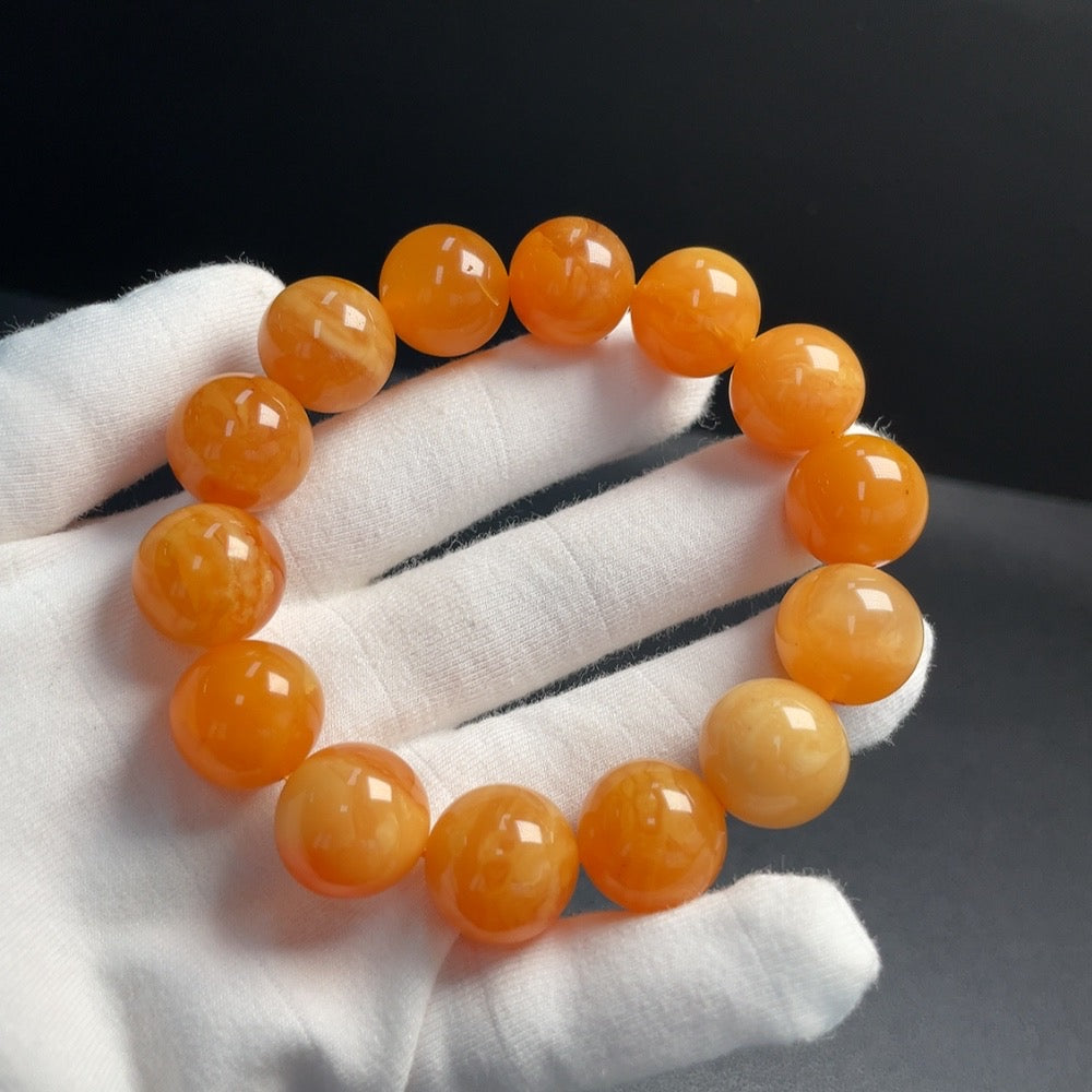 Amber beeswax bracelet, 16mm, natural amber jewelry by HUILIU HQ, showcasing smooth amber beads on a thread.