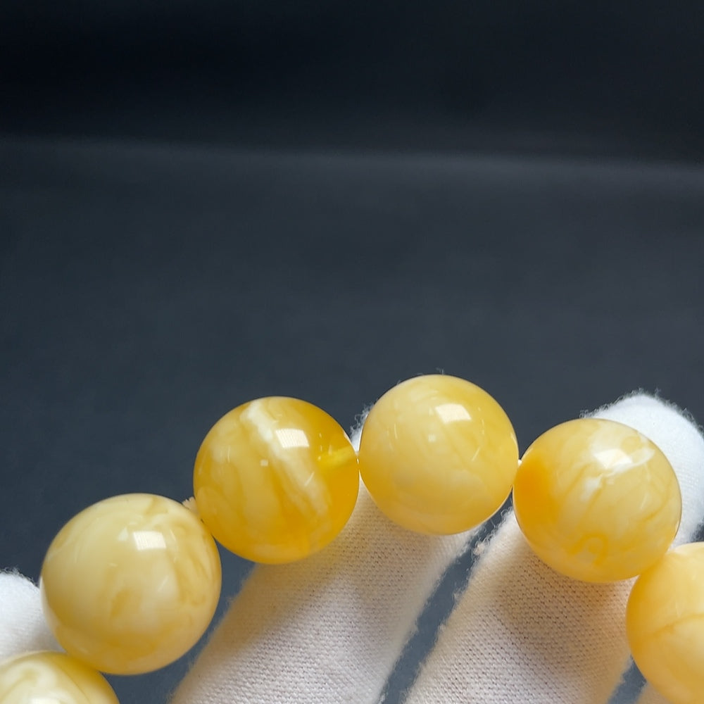 Huiliu Certified Amber Beeswax Bracelet with natural amber beads, showcasing warm, golden tones and handcrafted details.