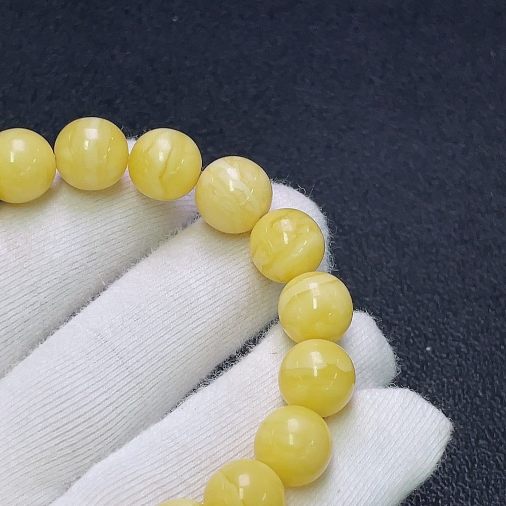 Huiliu HQ Amber Beeswax Bracelet, natural amber beads about 10.6mm, featuring warm honey tones and smooth polished surface.