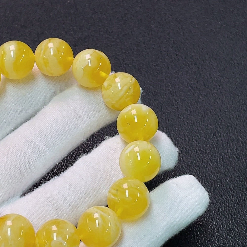 Huiliu Amber Beeswax Bracelet with 13.8mm beads, natural amber jewelry, Huiliu certified, featuring warm amber tones and smooth round beads.