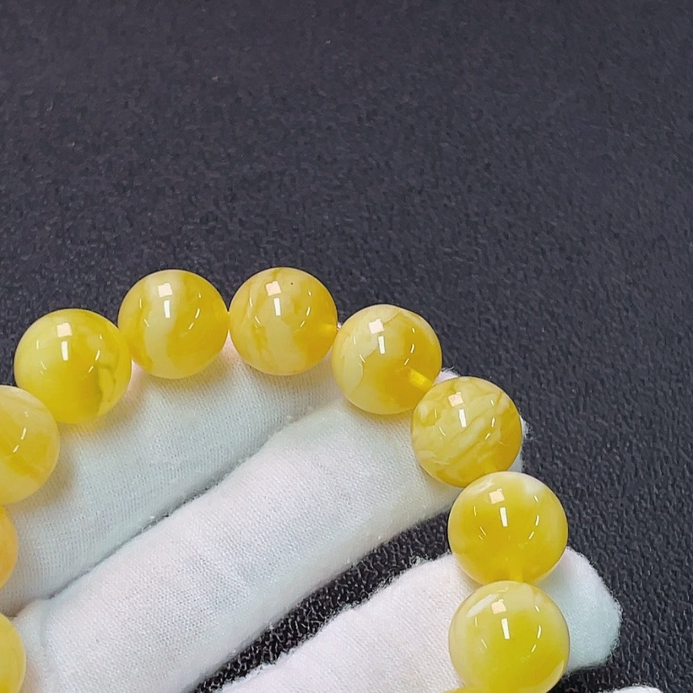 Huiliu HQ Amber Beeswax Bracelet with 13.8mm beads, natural amber jewelry, certified by Huiliu, showcasing polished amber beads.