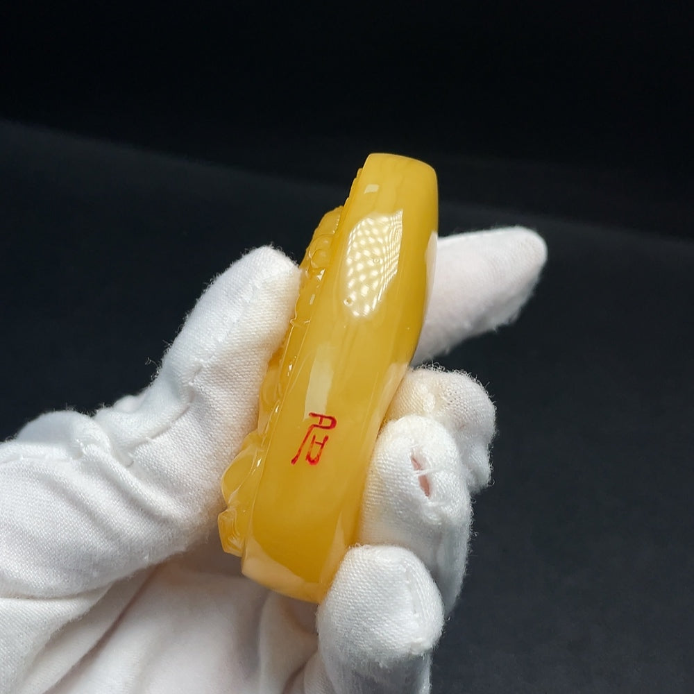 Huiliu HQ amber beeswax pendant with visible partial repairs, showcasing natural amber and craftsmanship.