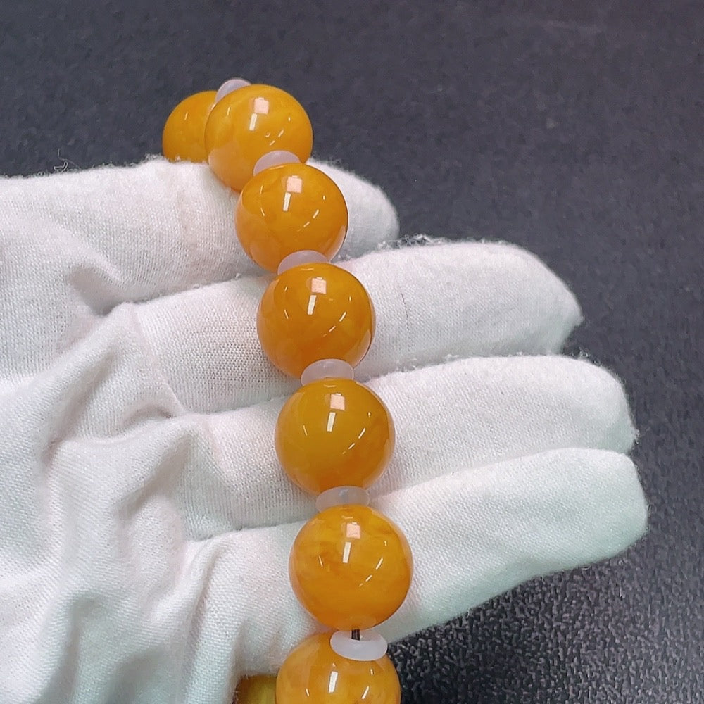 Amber Honey Wax Bracelet by HUILIU HQ with visible partial repairs, 16mm size, weighing approximately 31.9g, with stones that may not be natural.
