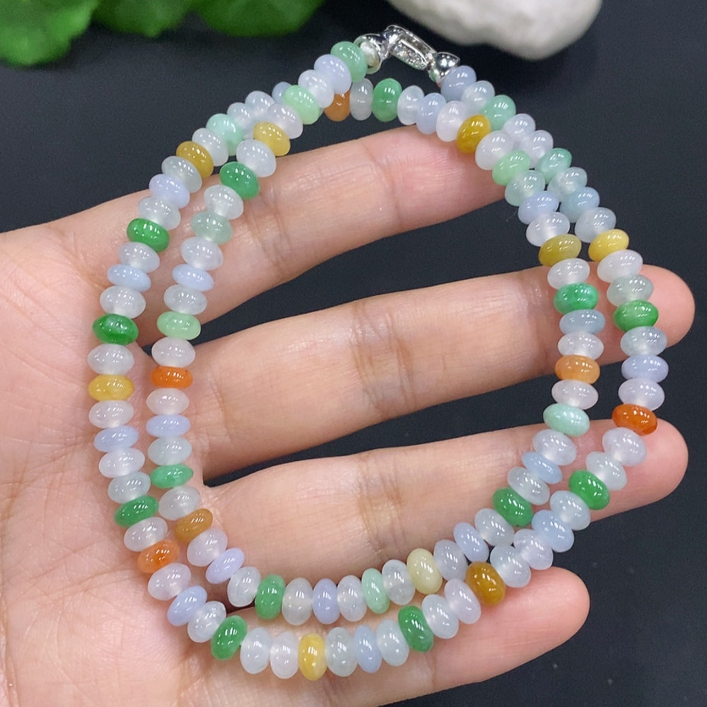 HUILIU HQ jade gemstone with an undetermined color origin, showcasing its smooth, polished surface and natural green hues.