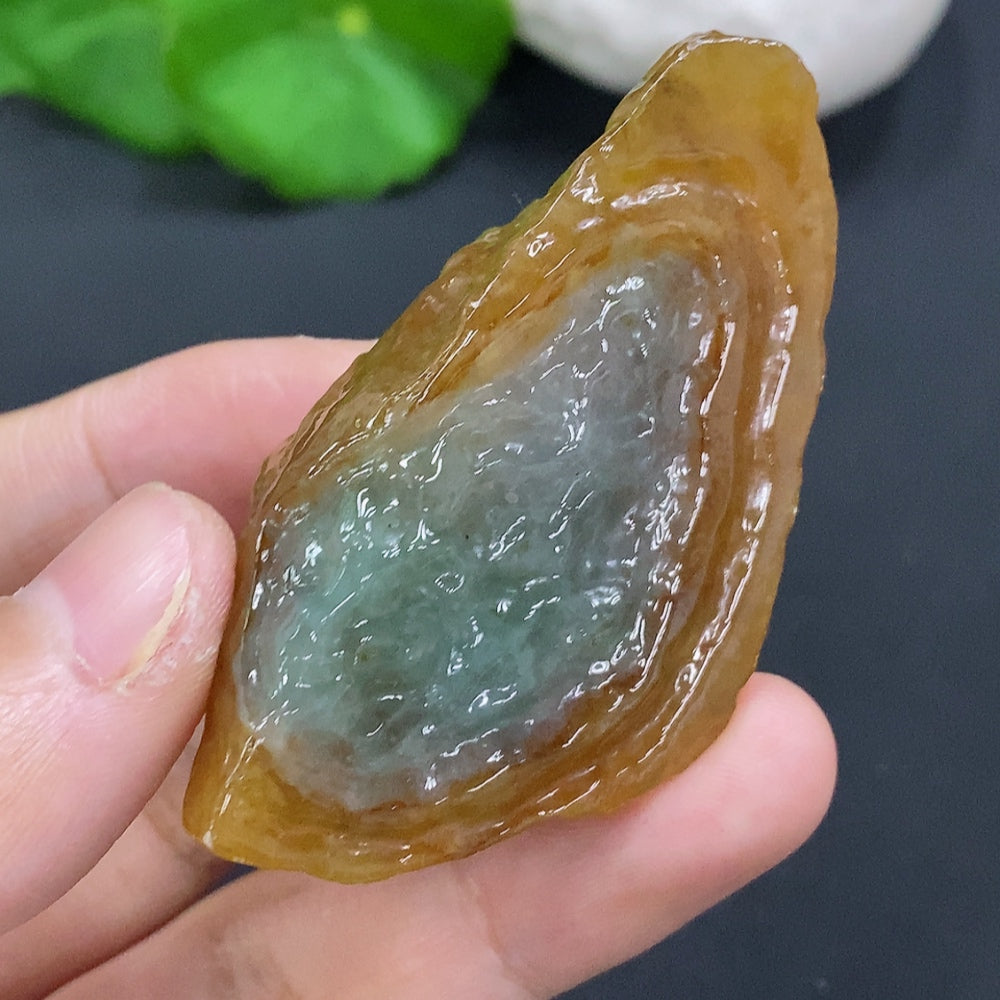 HUILIU HQ jade gemstone with an undetermined color origin, showcasing a smooth, polished surface and natural stone texture.