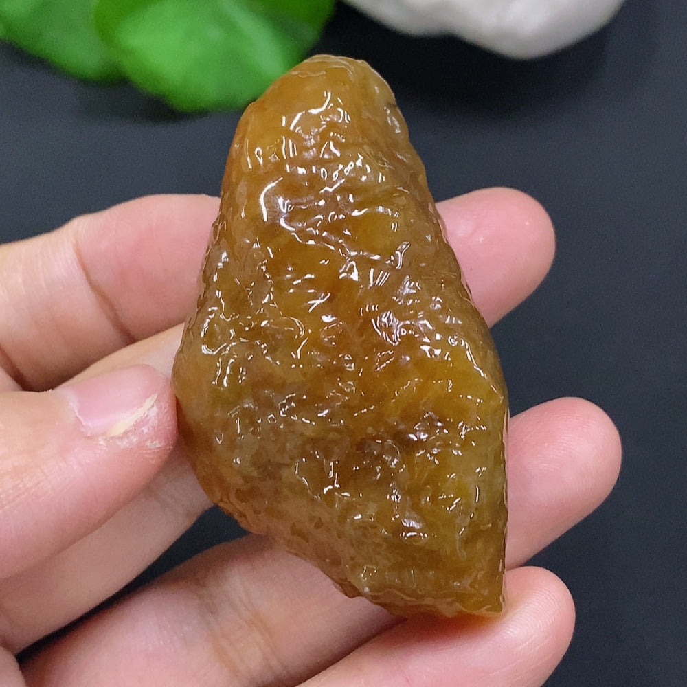 HUILIU HQ jade gemstone with a natural, undetermined color, showcasing smooth, polished surface and rich green hues.