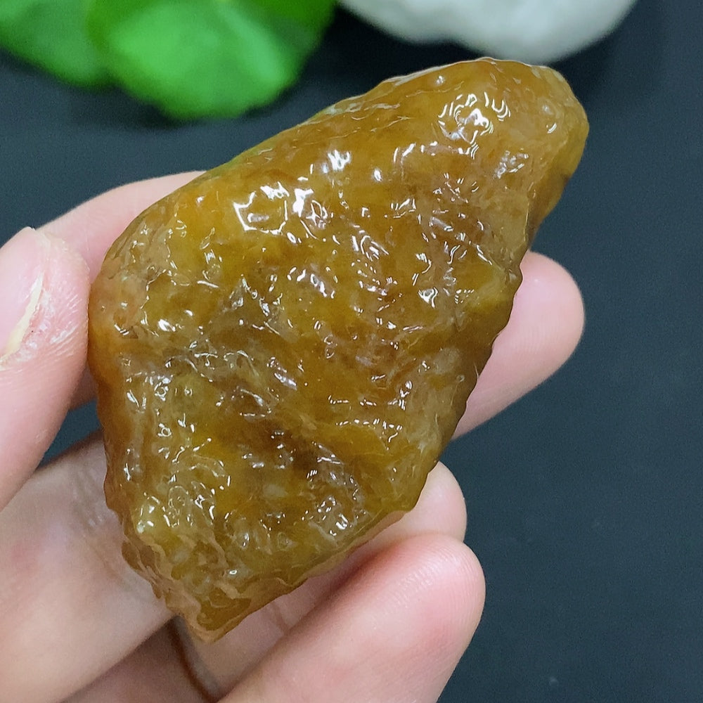 Natural jade gemstone from HUILIU HQ with a color that is undetermined, showcasing its smooth, polished surface.