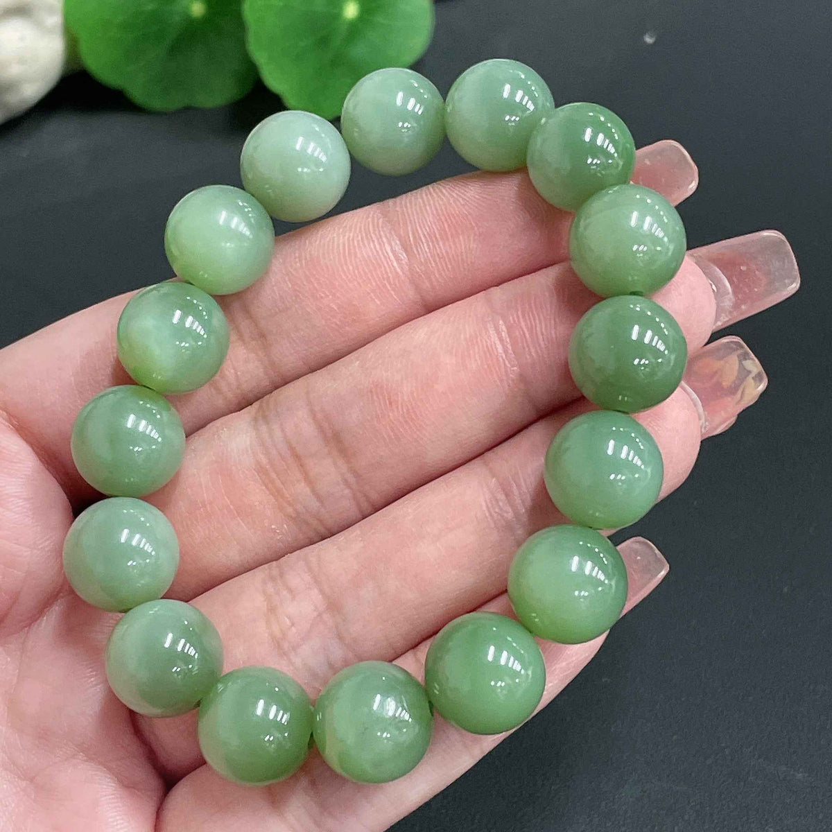 Huiliu certified Hetian Jade bracelet with 11.8mm round jade beads, showcasing smooth, polished green jade on a white background.