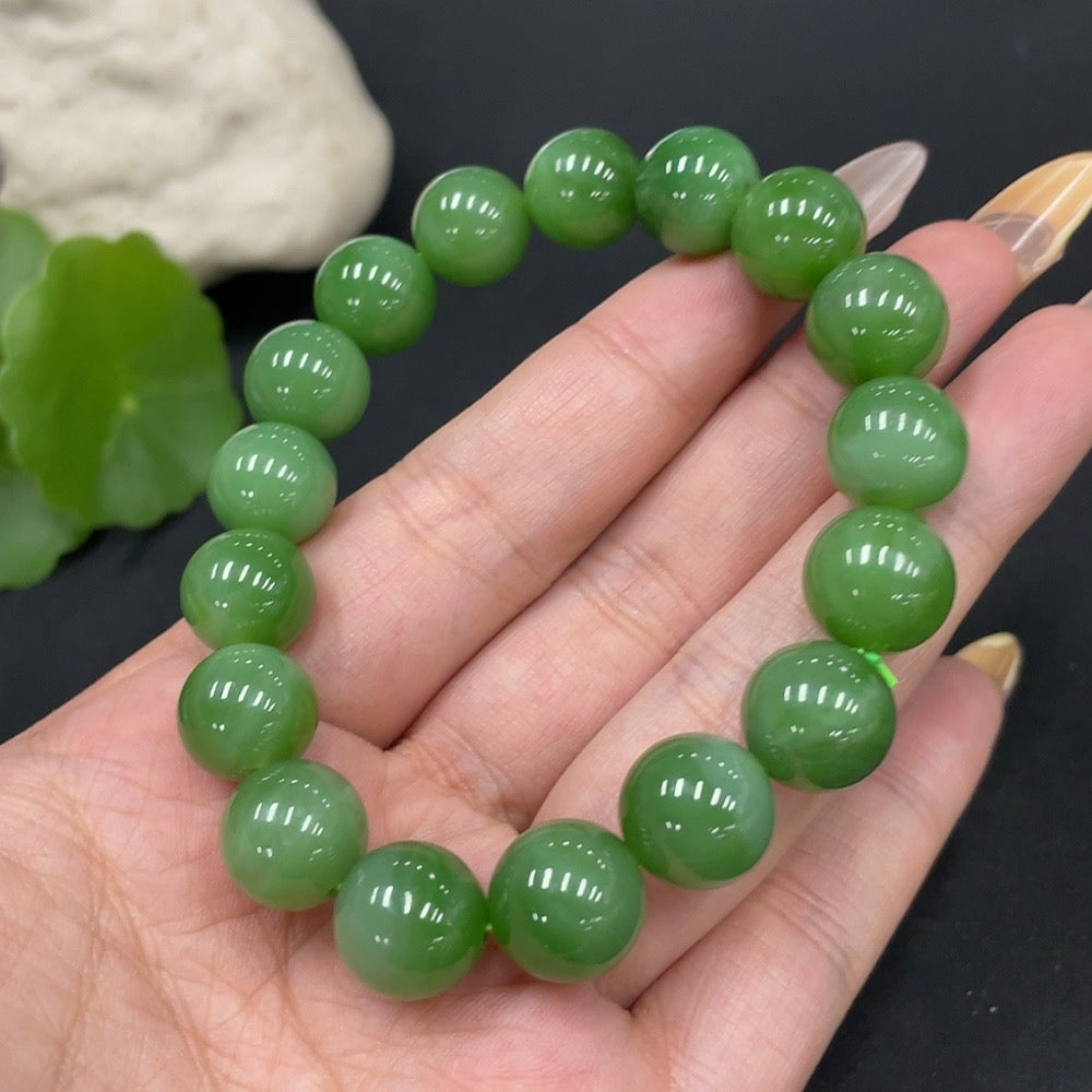 Hetian Jade bracelet by HUILIU HQ with 11.6mm beads, weighing approximately 42.2g, featuring smooth, polished jade stones.