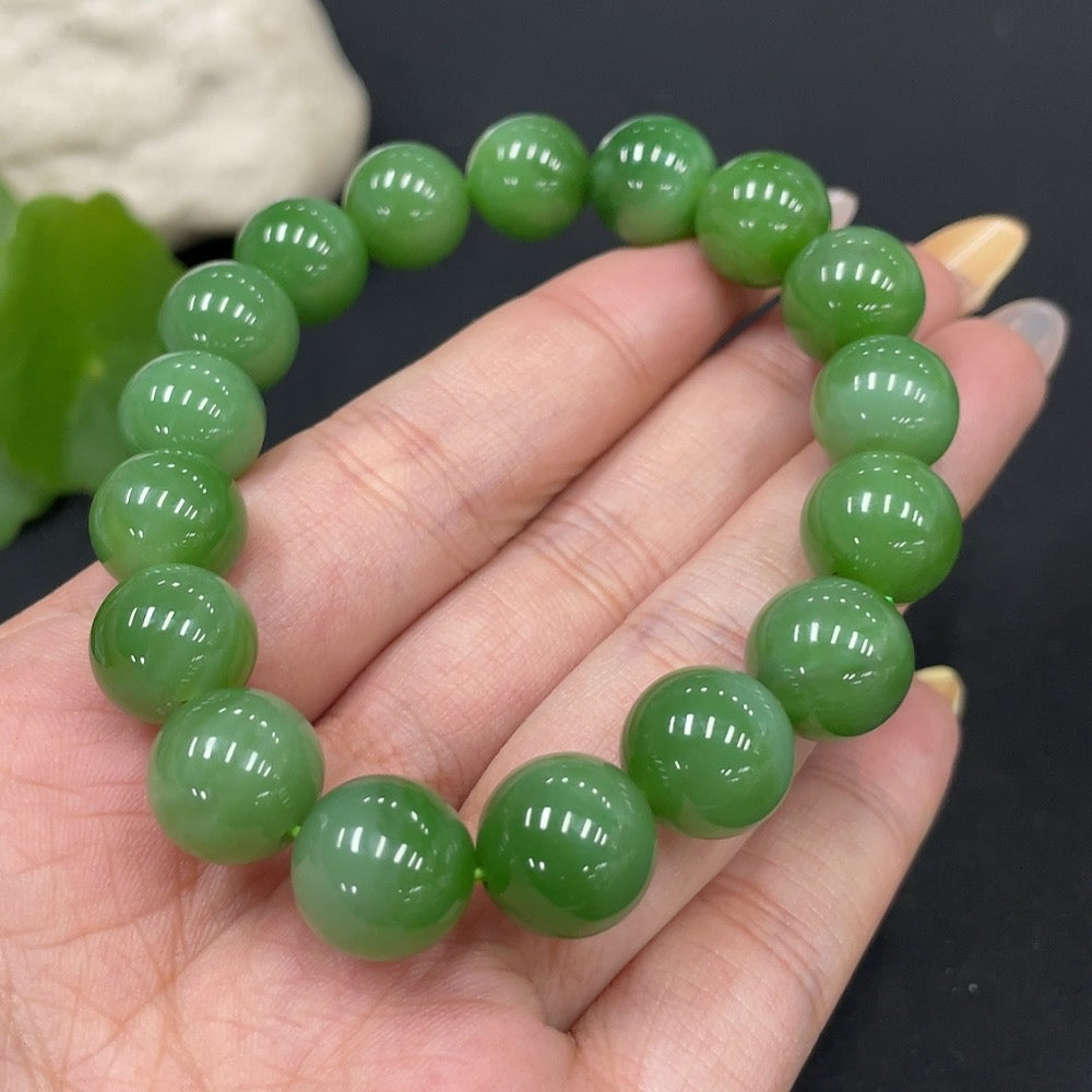Hetian jade bracelet by HUILIU HQ with 11.6mm beads and 42.2g weight, featuring smooth, polished jade stones on a flexible band.