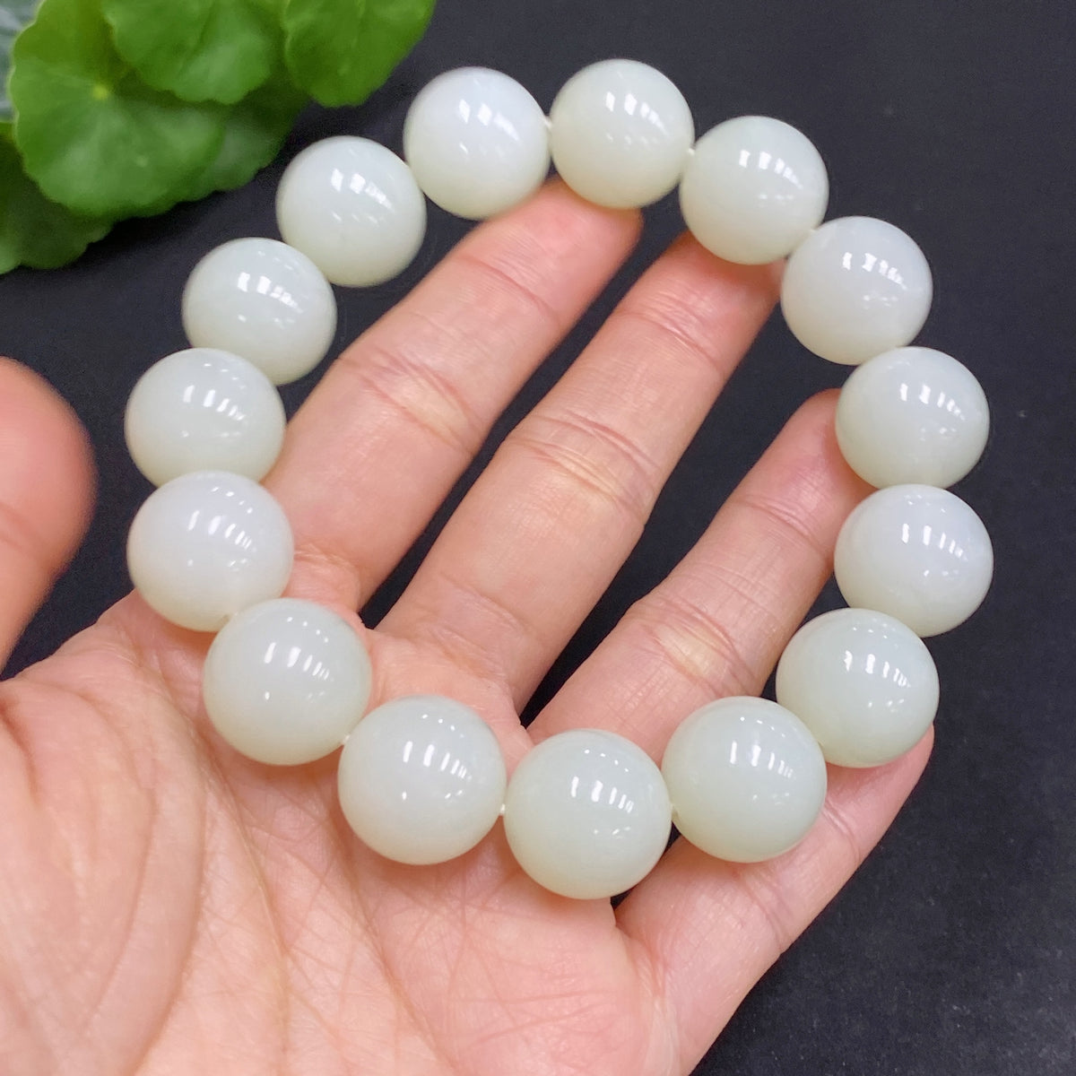 Huiliu HQ Hetian Jade bracelet with 14.8mm beads, showcasing smooth, polished green jade stones with a total weight of 77.9g.