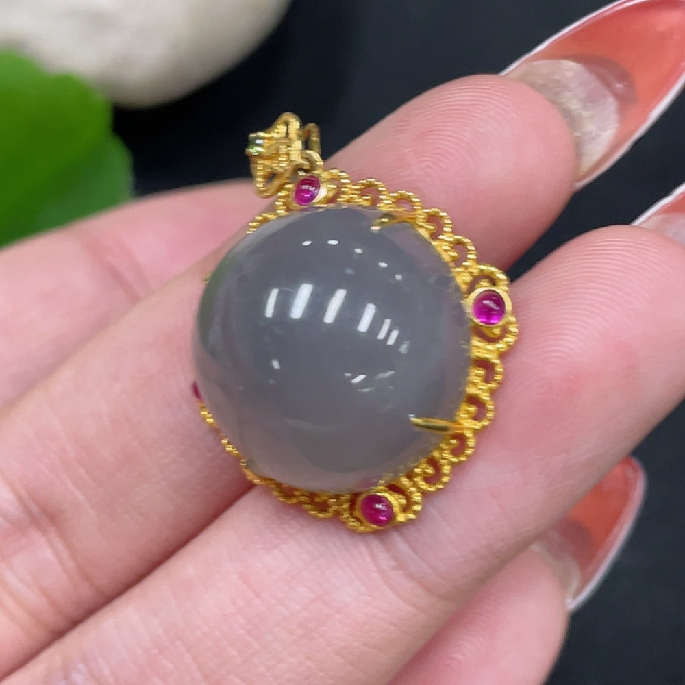 Hetian jade cabochon pendant with 18k gold setting, HUILIU HQ, showing the smooth, polished jade stone in an elegant gold frame.