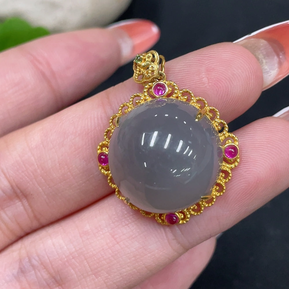 Hetian jade cabochon pendant with 18k gold setting, showing smooth green jade stone and gold bail, weight approx. 5.6g.