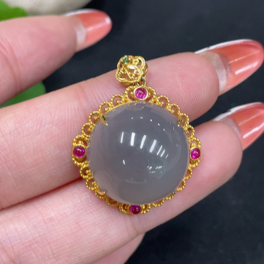 Hetian jade cabochon pendant with 18k gold setting, featuring a smooth, polished jade stone on a jewelry chain.