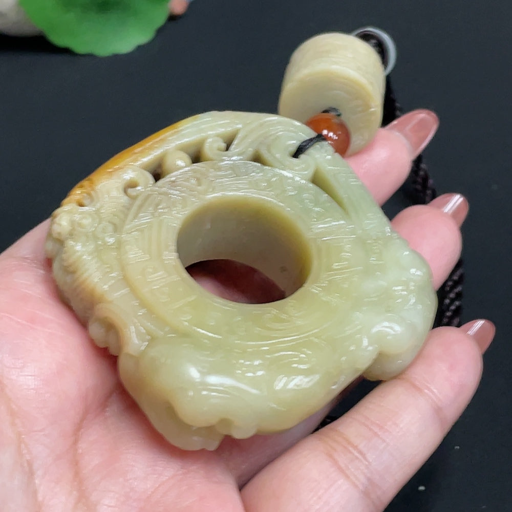Huiliu Certified Hetian Jade handheld carving in antique style, showcasing intricate jade craftsmanship on a polished stone piece.