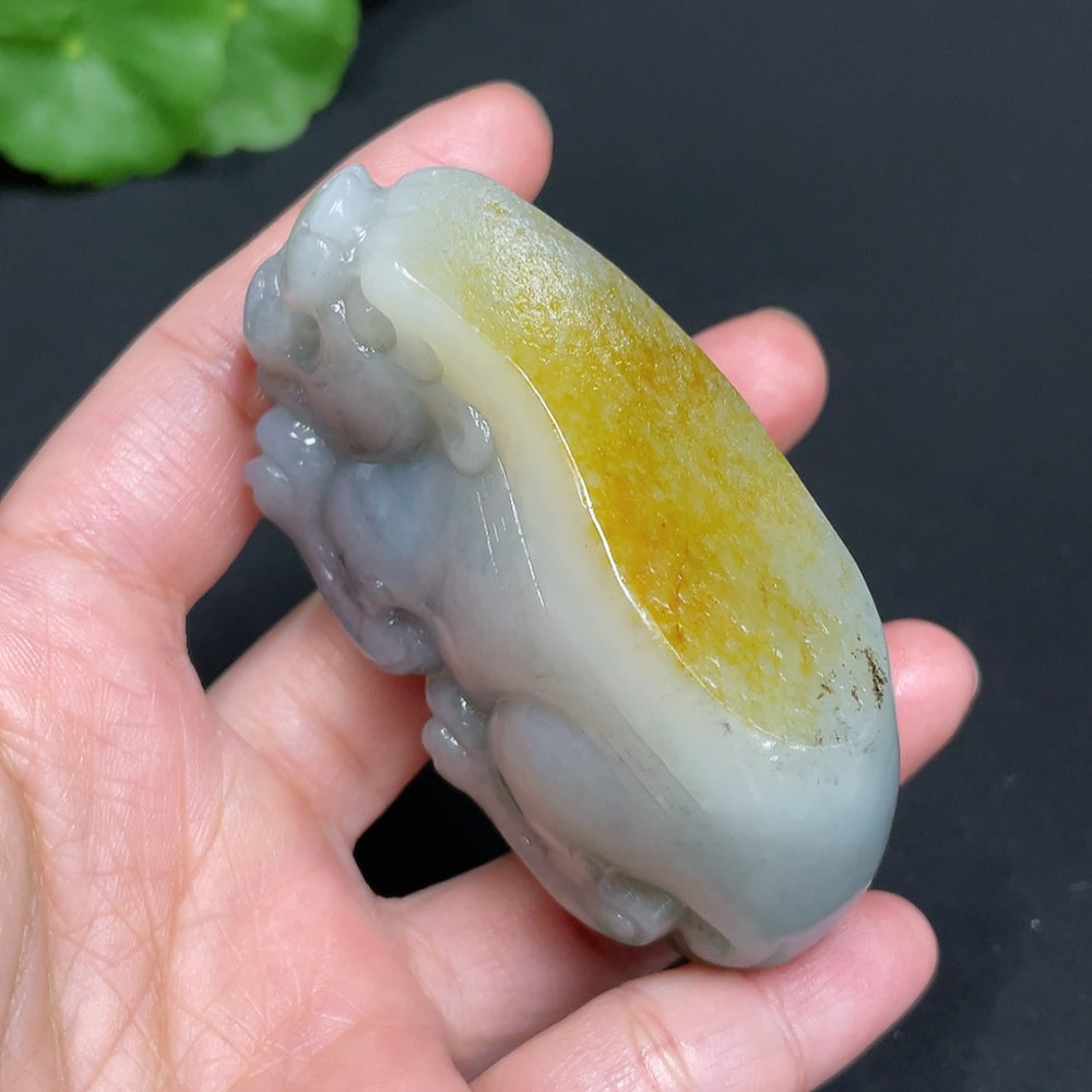 Huiliu certified Hetian jade handheld piece featuring an auspicious beast design, with undetermined skin color and authentic origin.
