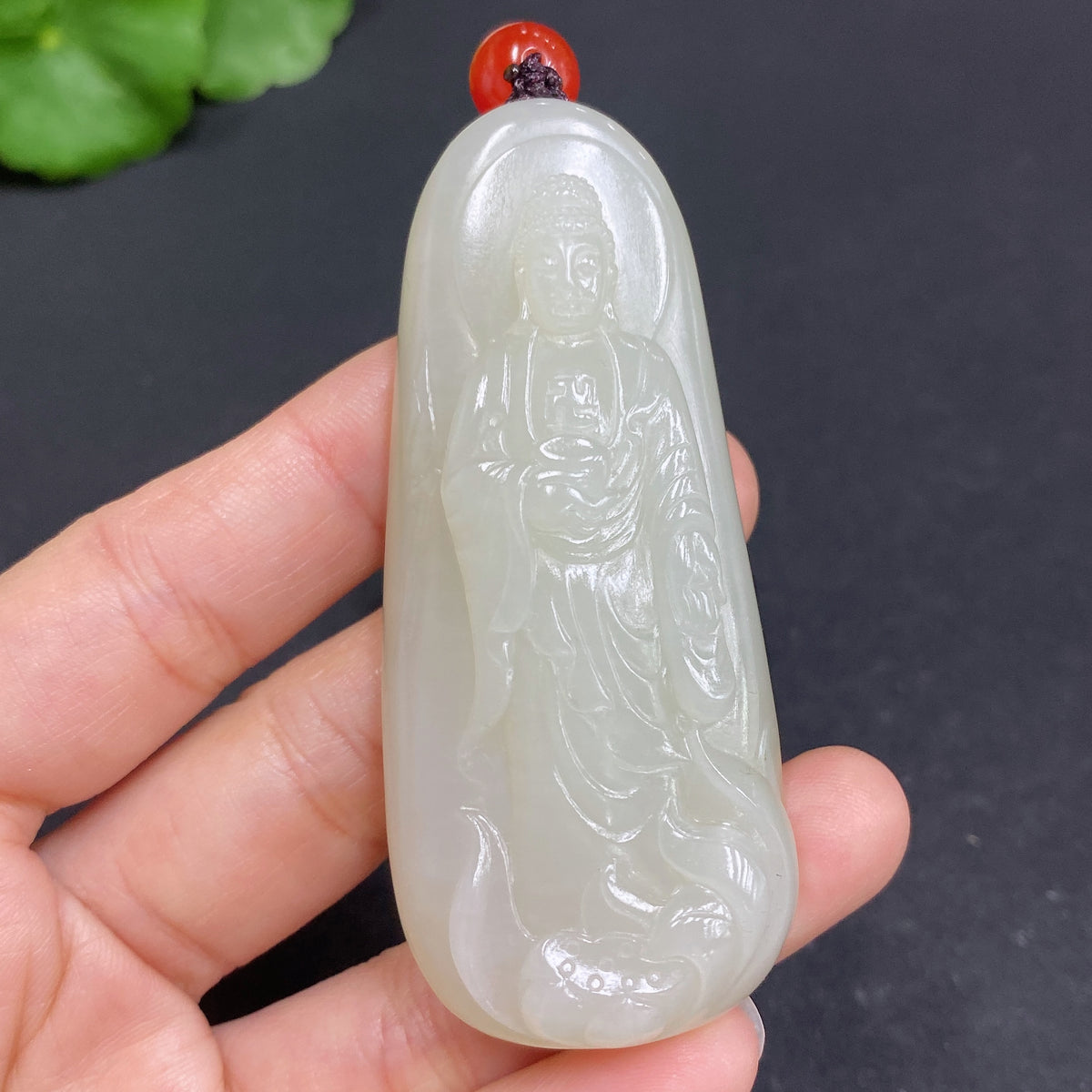Hetian jade pendant featuring Amitabha Buddha, crafted from smooth green jade with intricate carved details.