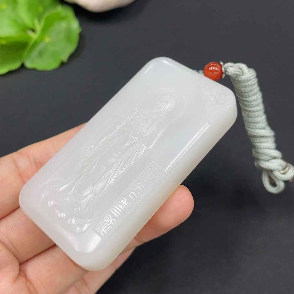 Hetian jade pendant featuring Amitabha Buddha, weighing approx. 78.4g with rope, showcasing natural jade color and intricate design.