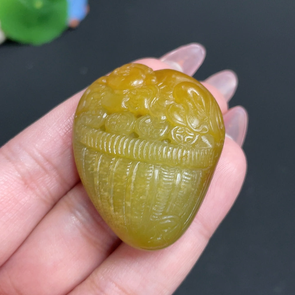 Huiliu certified Hetian jade pendant featuring a Buddha figure with undetermined skin color, crafted from smooth green jade.