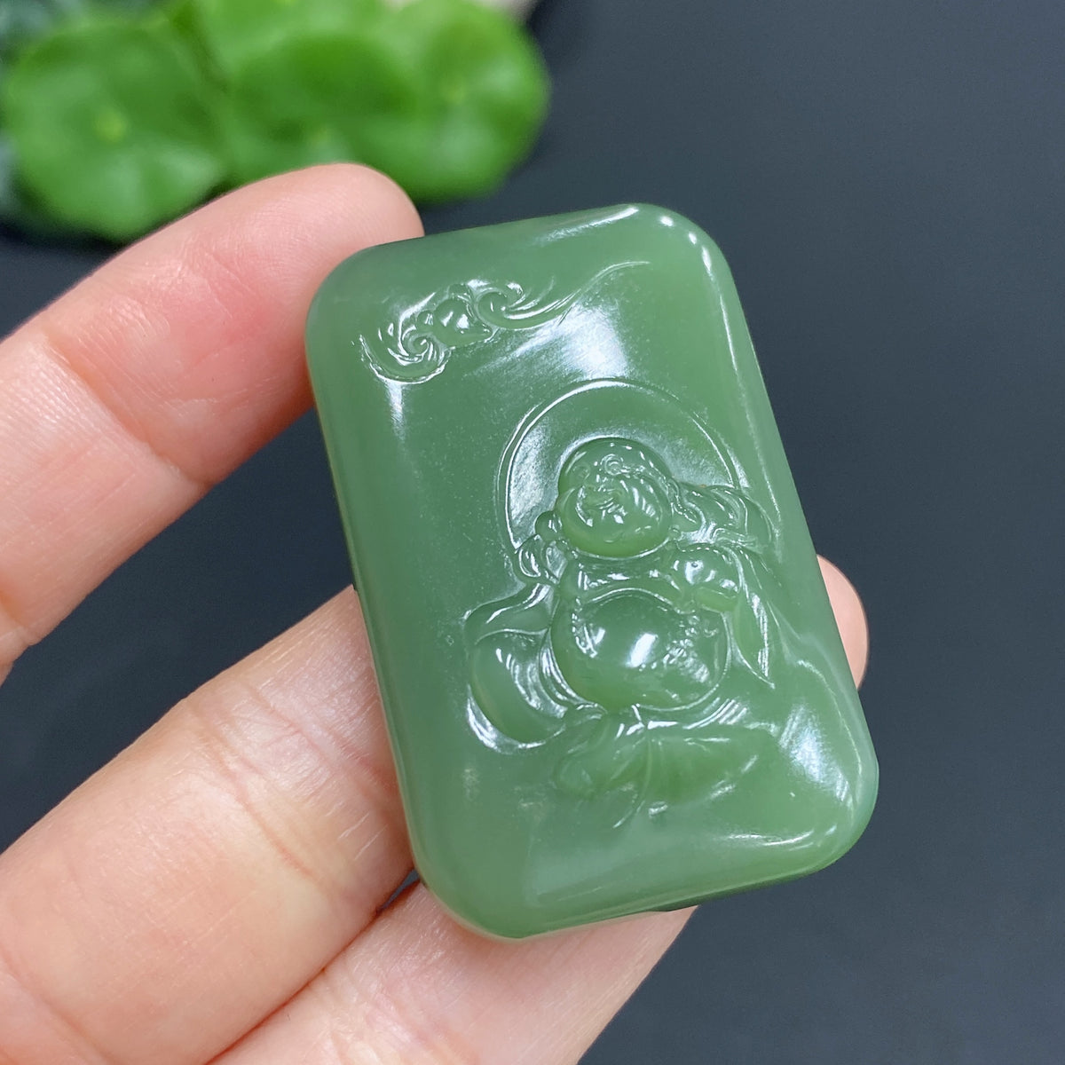 Hetian Jade Buddha pendant weighing approximately 24.5g, crafted by HUILIU HQ, showcasing detailed jade carving.