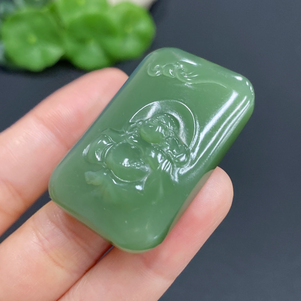 Hetian Jade Buddha pendant from HUILIU HQ, intricately carved, weighing approximately 24.5g, showcasing natural jade beauty.