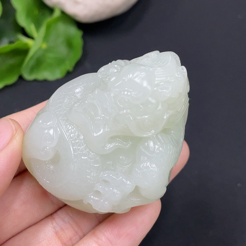 Huiliu certified Hetian jade pendant featuring a detailed dragon design, displayed with collection card.