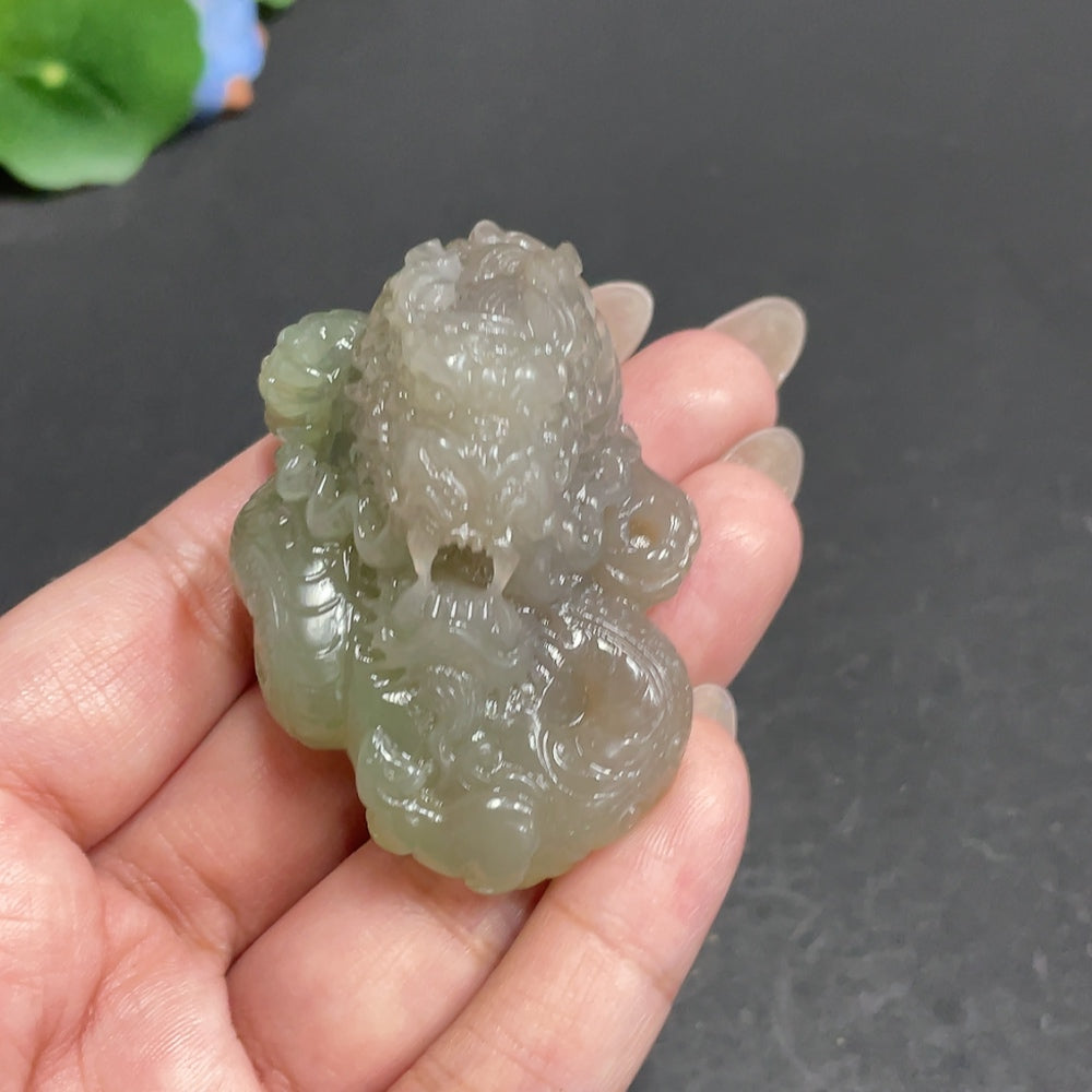 Huiliu Certified Hetian Jade Pendant featuring a detailed dragon roaming the world, crafted from high-quality green jade.