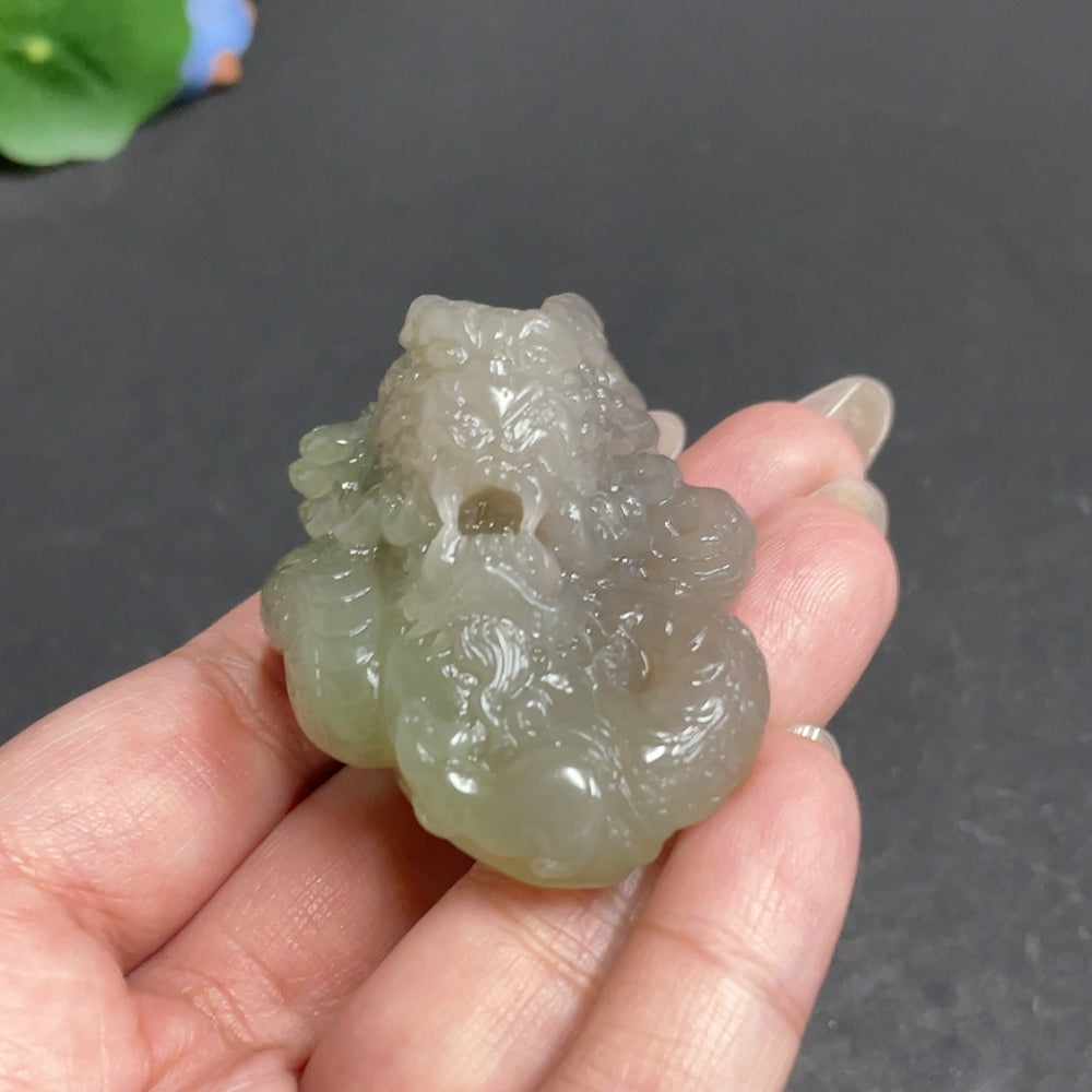 Huiliu Certified Hetian jade pendant featuring a dragon roaming the world, crafted from smooth, green jade with detailed carvings.
