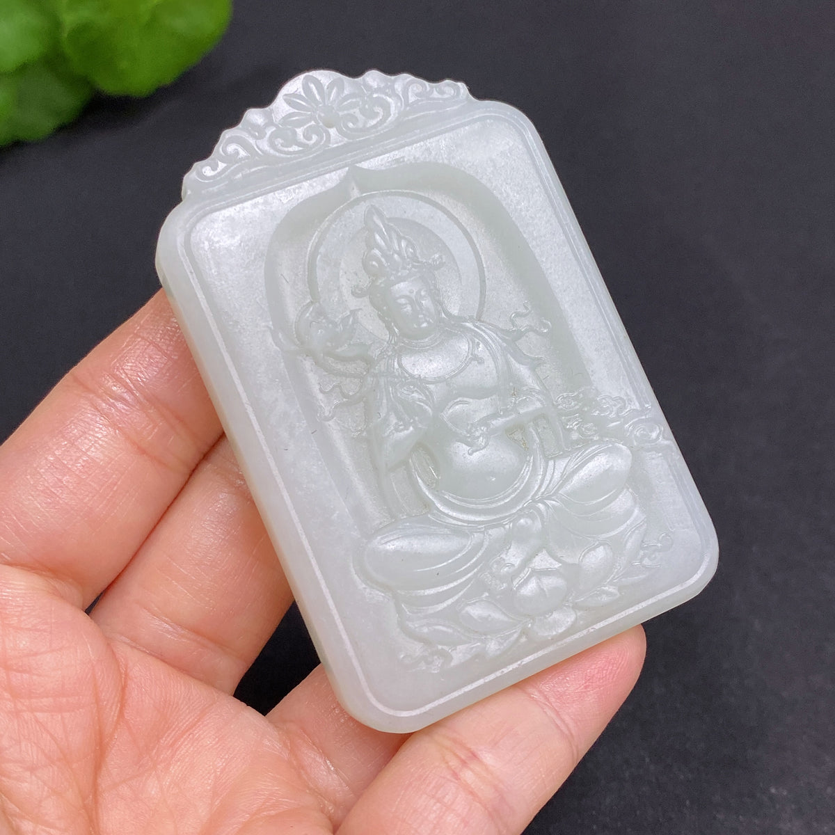 Huiliu certified Hetian Jade Pendant featuring Guanyin figure, smooth polished surface, and intricate carved details.