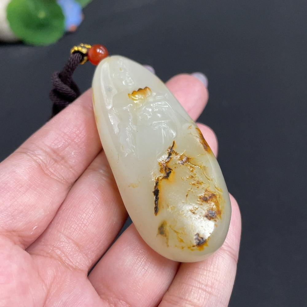 Hetian jade pendant featuring Guanyin, symbol of blessings, crafted by HUILIU HQ with intricate carved design.