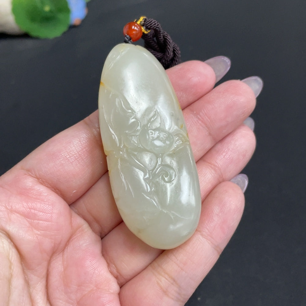 Hetian jade pendant featuring Guanyin, crafted by HUILIU HQ, showcasing intricate design and smooth, polished surface.