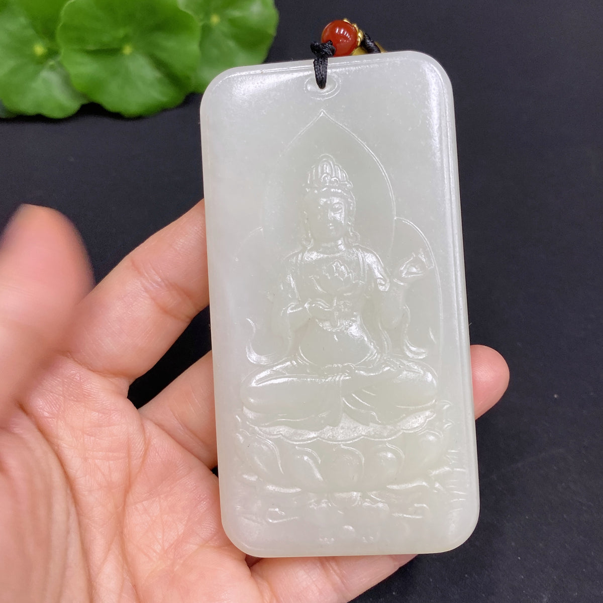 Huiliu certified Hetian jade Guanyin pendant with rope, showcasing intricate carved details and smooth polished surface.