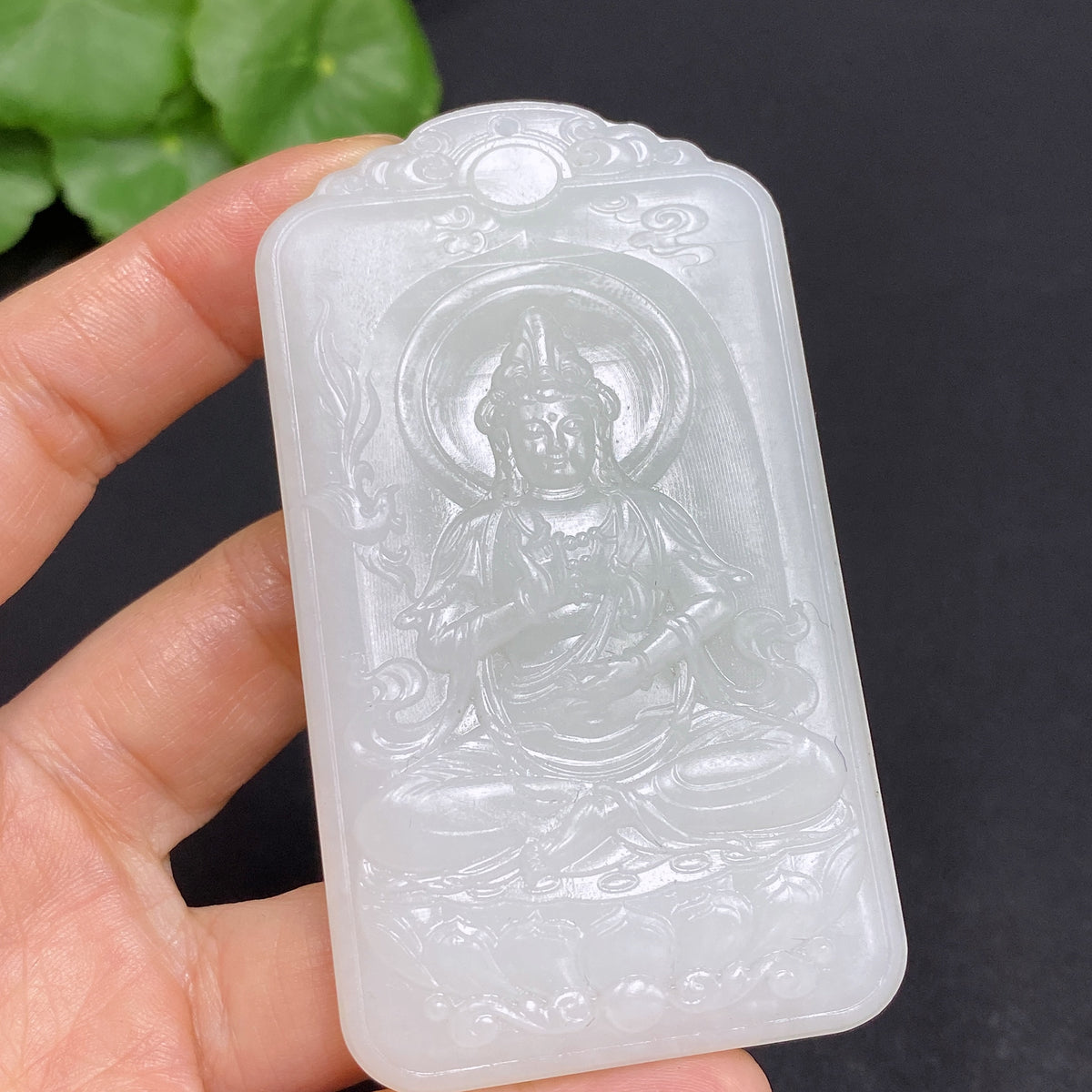 Huiliu certified Hetian jade pendant featuring Guanyin figure, smooth polished surface, and intricate carved details.