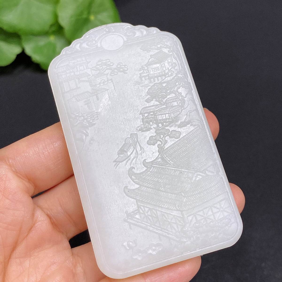 Huiliu-certified Hetian jade pendant featuring Guanyin figure, showcasing smooth green jade craftsmanship.