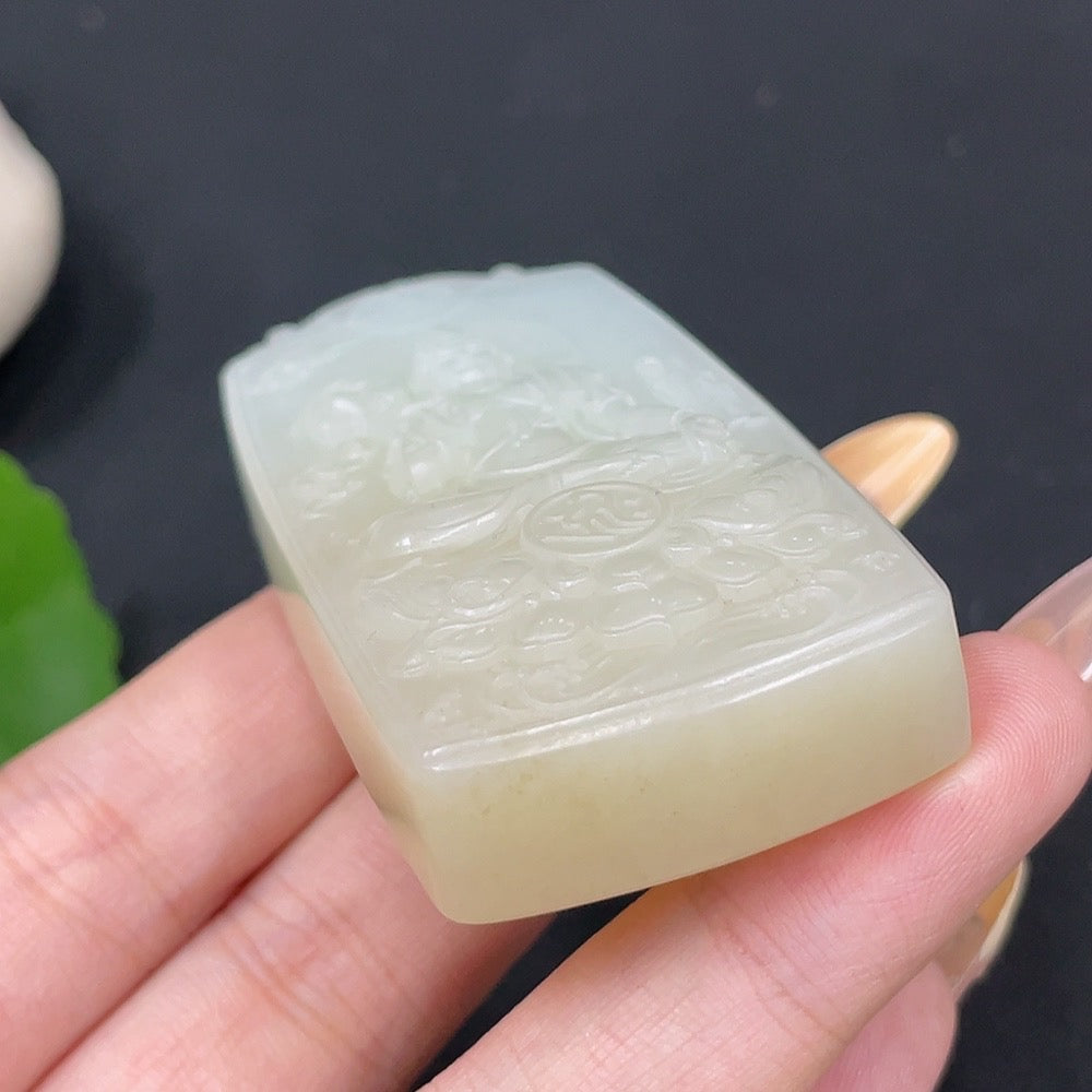 Huiliu Certified Hetian Jade Pendant featuring Guanyin figure, polished jade with intricate carved details, hanging on a silk cord.