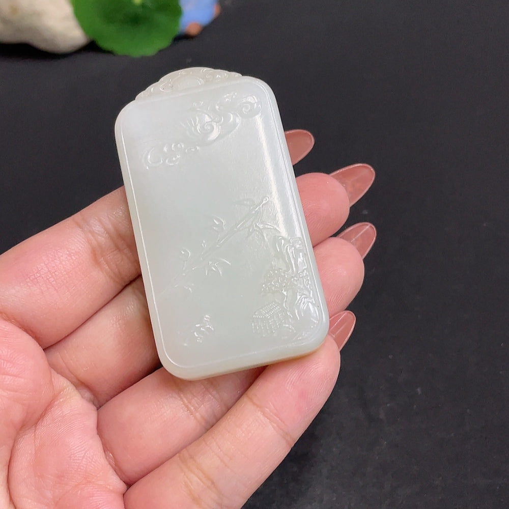 Huiliu certified Hetian jade Guanyin pendant showcasing intricate craftsmanship and smooth, polished jade surface.