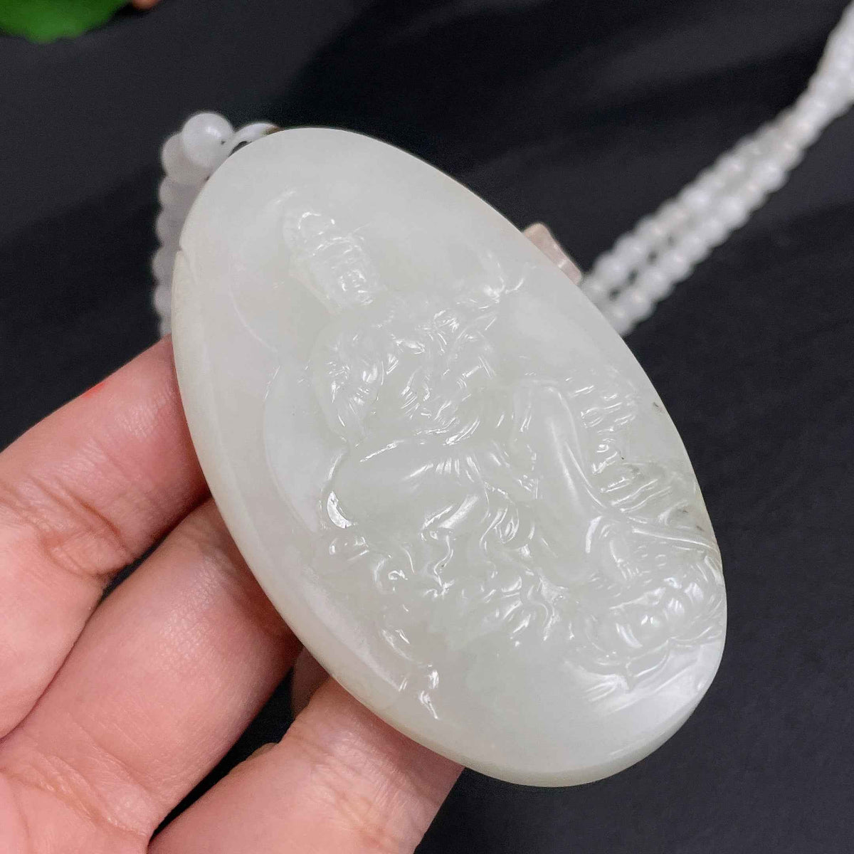 Hetian Jade Guanyin pendant with chain, crafted by HUILIU HQ, featuring a detailed carved figure on a jade bead necklace.
