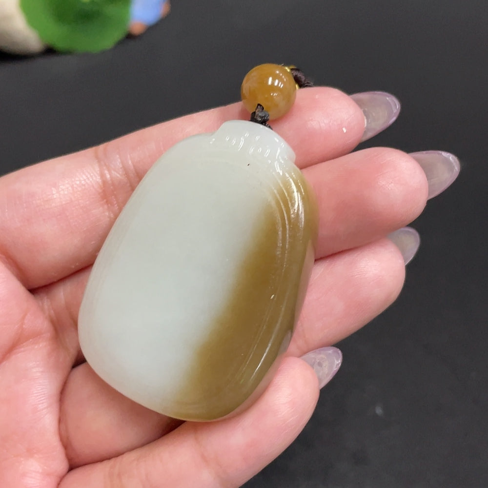 Huiliu certified Hetian jade pendant featuring a smooth, plain design, showcasing the natural white jade stone and craftsmanship.
