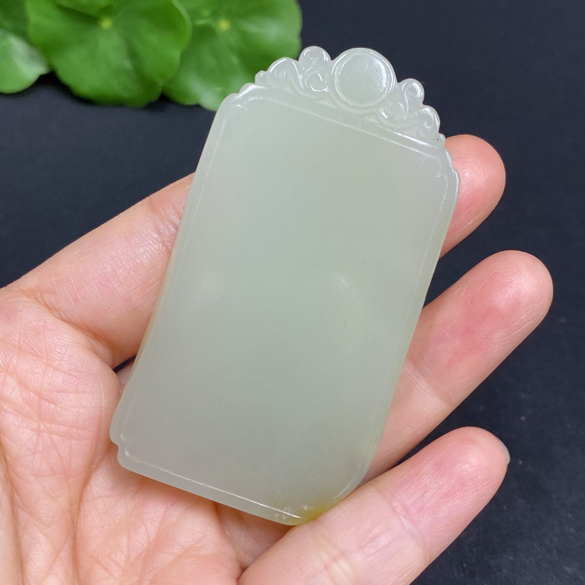 Hetian jade pendant by HUILIU HQ, plain design, weighing about 47g, with undetermined skin color origin and smooth surface.