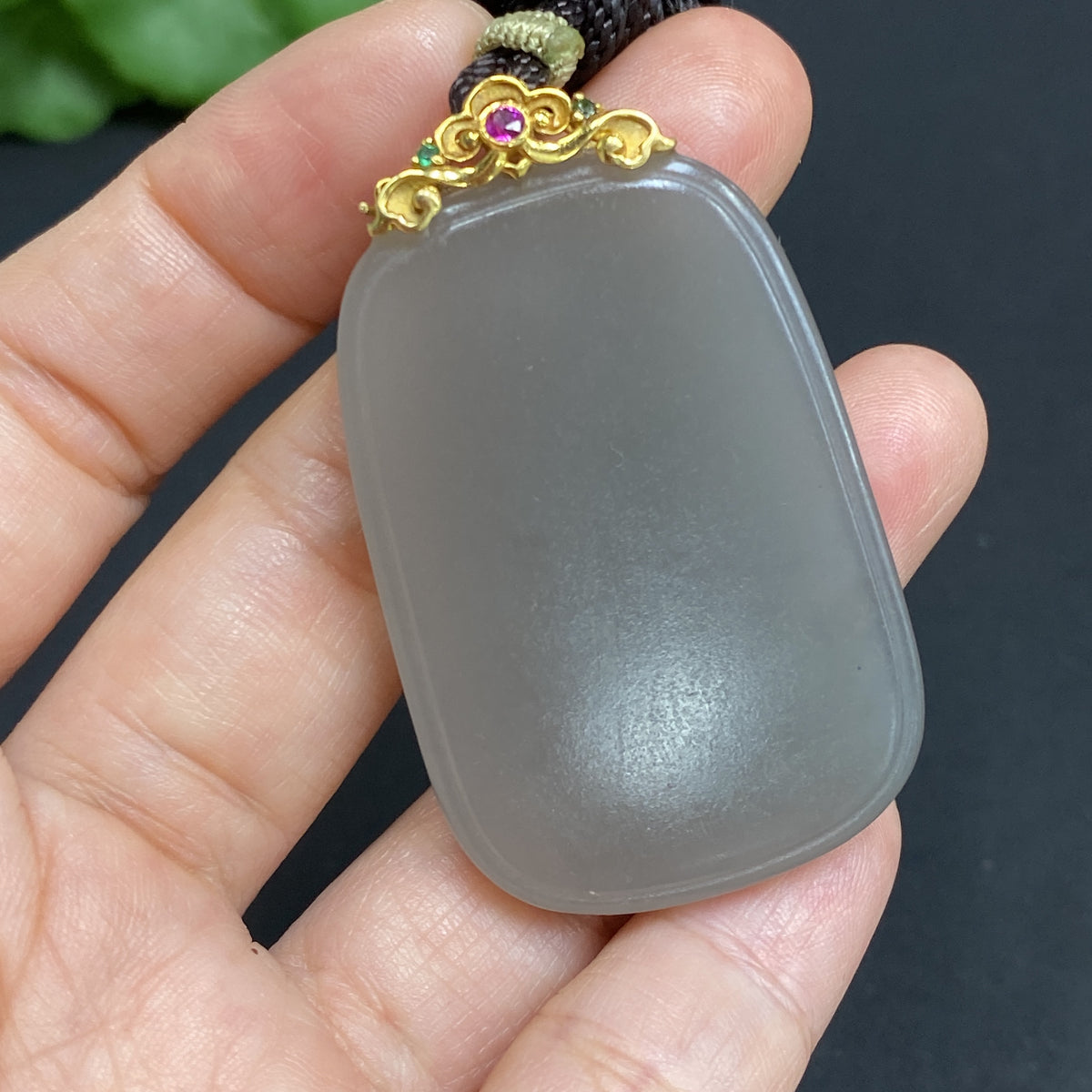 Huiliu HQ Hetian jade pendant with plain design, clasp, and rope, showcasing the smooth, polished jade surface and craftsmanship.