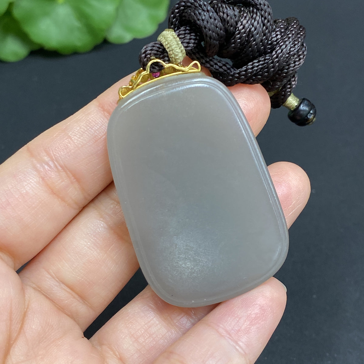 Huiliu certified Hetian jade pendant with plain design, clasp, and included rope for elegant jewelry display.