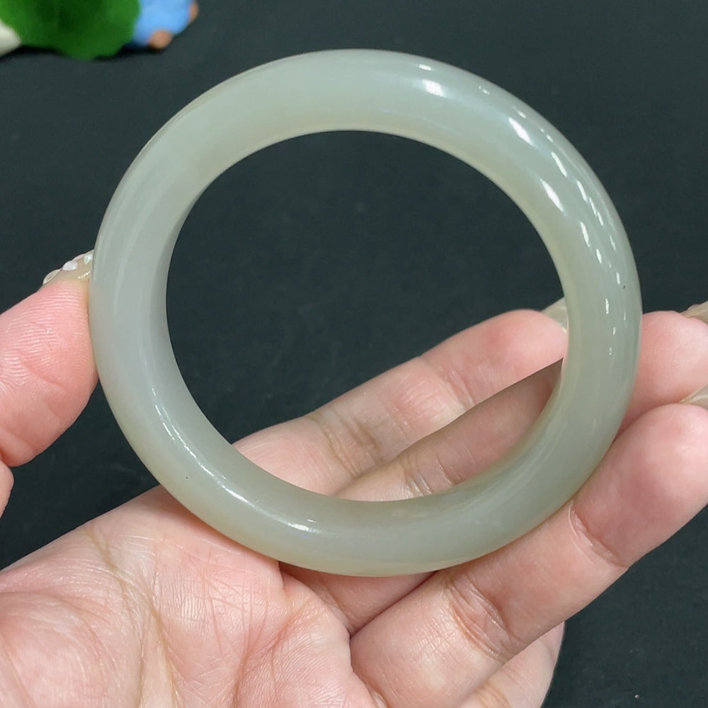 Huiliu Certified Hetian Jade round bracelet with smooth polished surface, showcasing traditional craftsmanship and elegant design.