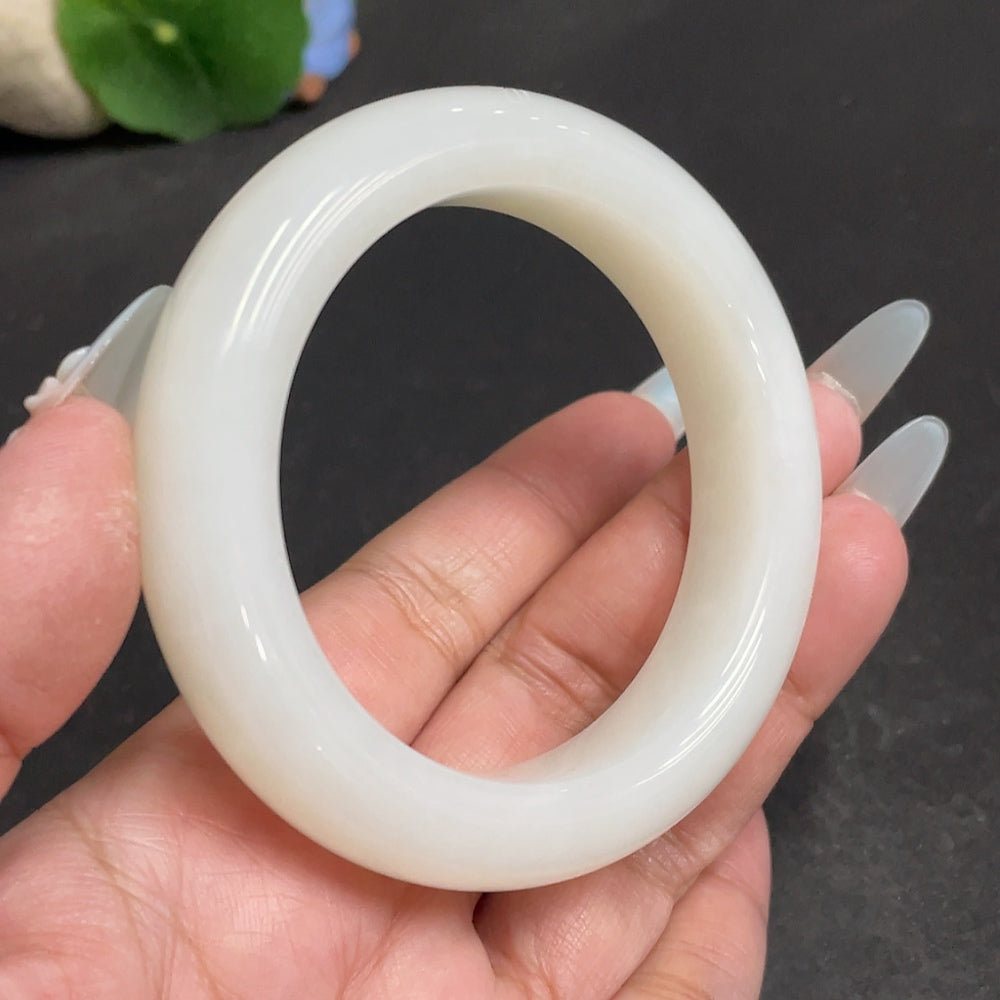 Huiliu Certified Hetian Jade round bracelet with smooth polished surface, showcasing elegant jade craftsmanship.