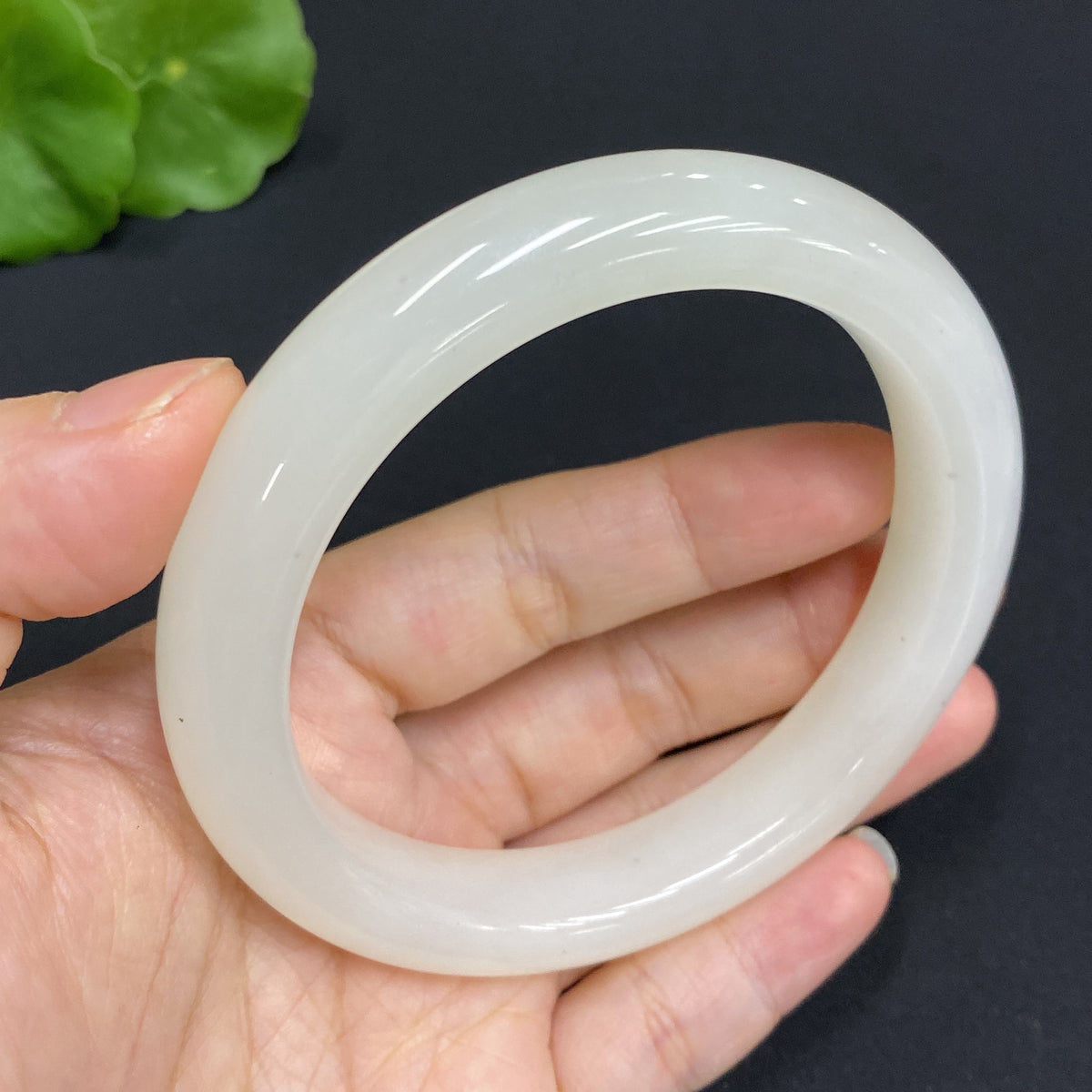 Hetian Jade round bracelet by HUILIU HQ, size 60.9, weighing approximately 63.7g, featuring smooth, polished jade beads.