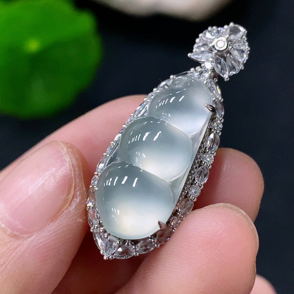 Jadeite blessed bean pendant set in 18k gold with diamond accents, featuring a stylish jade pendant and matching chain.